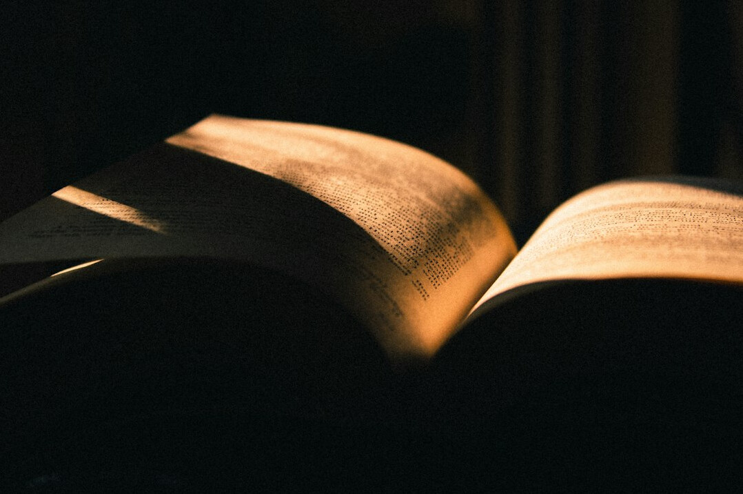 Open book with pages lit by warm light