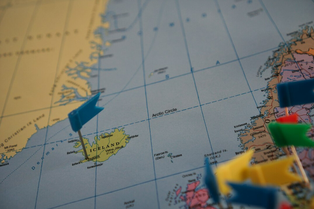 Paper map spread on a table with pins